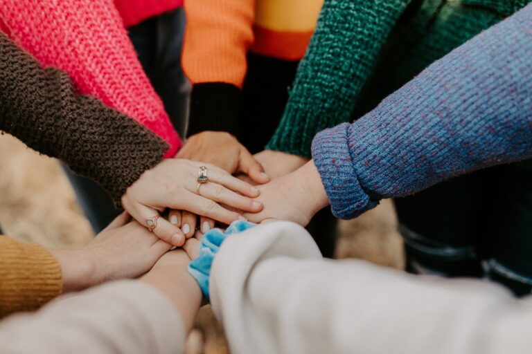 Hands joined to show support and community.